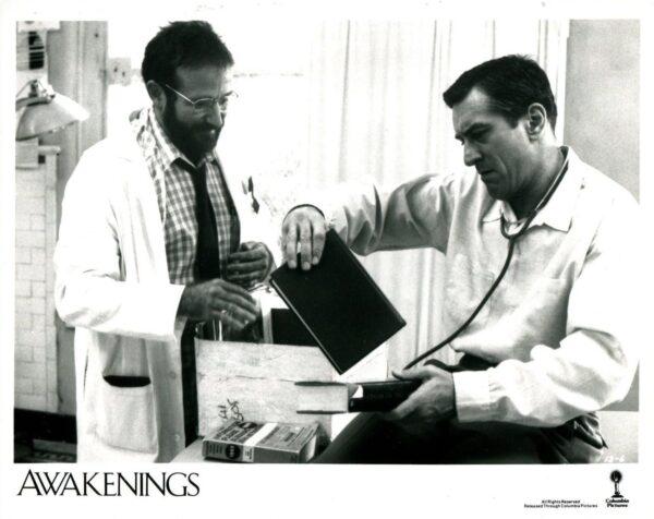 Lobby card showing Dr. Sayer (Robin Williams, L) on his rounds visiting an improving Leonard Lowe (Robert De Niro), in "Awakenings." (MovieStillsDB)