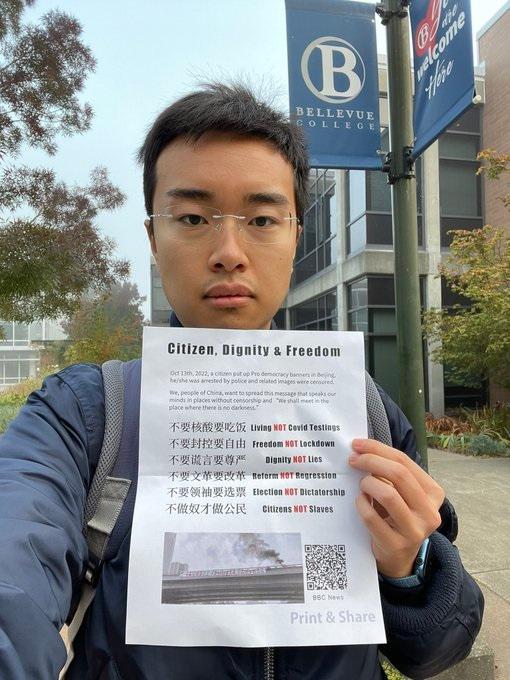 Han Yutao holds a flyer he distributed on the campus of Bellevue College, Washington, on Oct. 18, 2022, that expresses his support for the Beijing Sitong Bridge protest. (Provided by interviewee)
