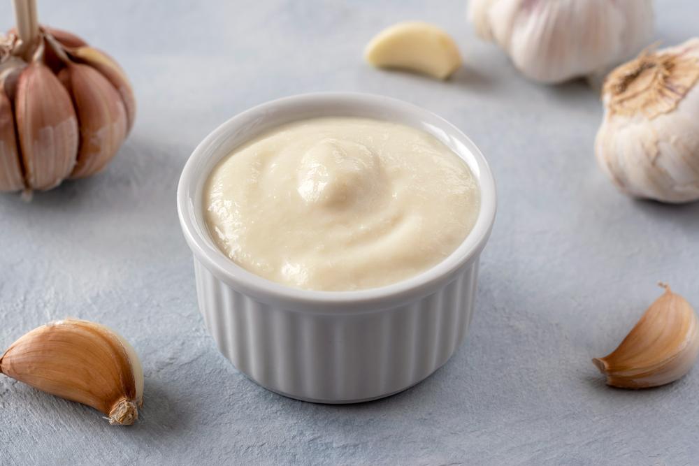 Toum, a thick, fluffy Lebanese garlic spread, takes four ingredients and improves just about anything.(beaulaz/Shutterstock)