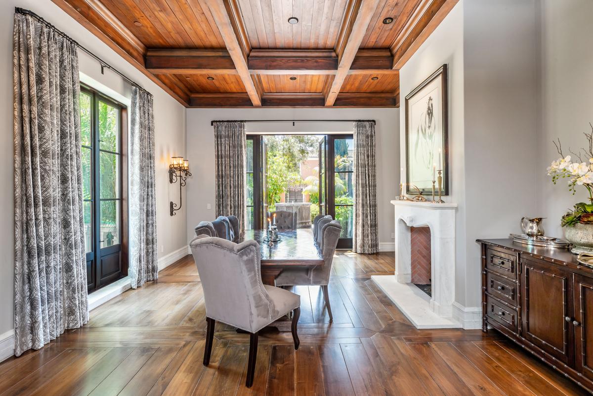 The formal dining area is accented by views of the manicured landscape surrounding the principal residence. (Courtesy of Simon Berlyn for Sotheby’s International Realty)