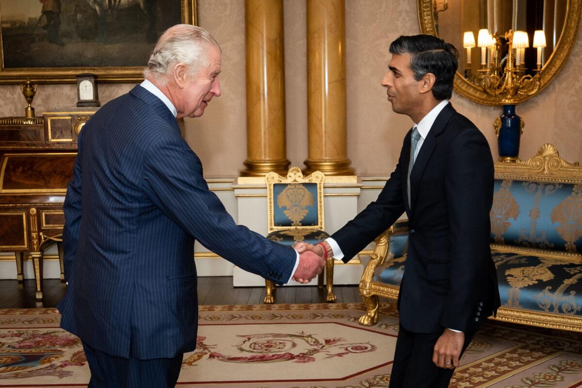 King Charles III welcomes Rishi Sunak during an audience at Buckingham Palace, where he invited the newly elected leader of the Conservative Party to become prime minister and form a new government, in London, on Oct. 25, 2022. (Aaron Chown - WPA Pool/Getty Images)