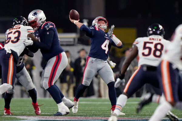 New England Patriots quarterback Bailey Zappe (4) throws a deep pass to wide receiver DeVante Parker during the first half of an NFL football game against the Chicago Bears, in Foxborough, Mass., on Oct. 24, 2022. (Steven Senne/AP Photo)