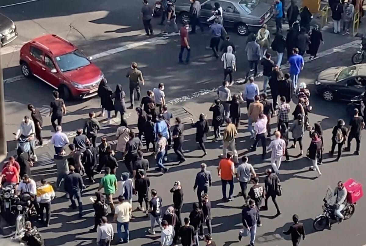 People block an intersection during a protest to mark 40 days since the death in custody of 22-year-old Mahsa Amini, whose tragedy sparked Iran's biggest antigovernment movement in over a decade, in Tehran, Iran, on Oct. 26, 2022, in this frame grab from video taken by an individual not employed by the Associated Press and obtained by the AP outside Iran. (AP Photo)