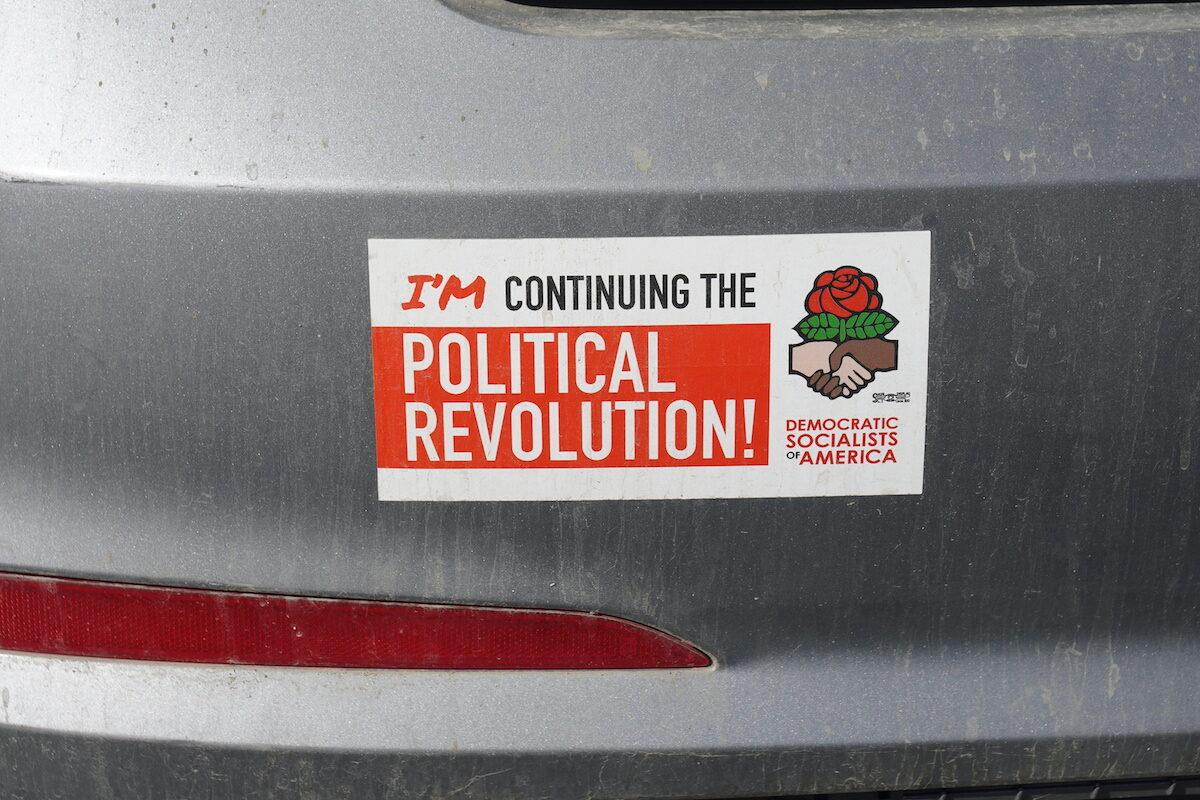 A pro-socialism bumper sticker in the employee parking lot of Grants Pass High School in Grants Pass, Oregon on Oct. 18, 2022. (Jackson Elliott/The Epoch Times)