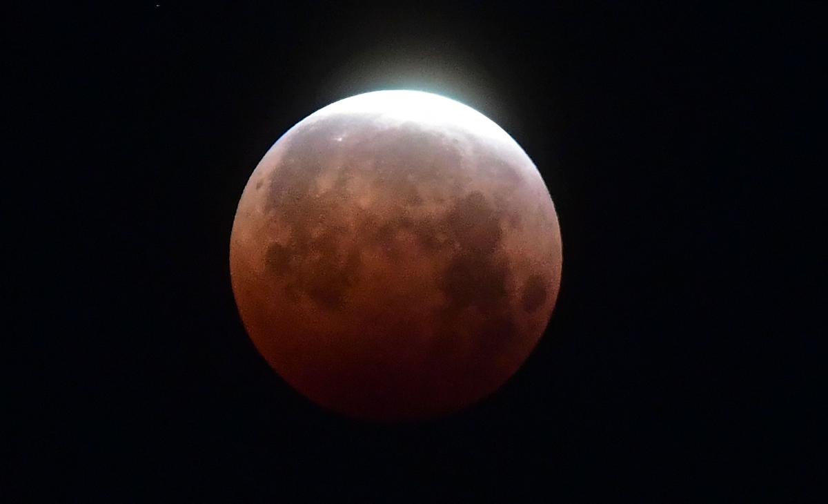 The Moon as seen over Santa Monica, California, on May 26, 2021, during the "Super Blood Moon" total eclipse. (FREDERIC J. BROWN/AFP via Getty Images)