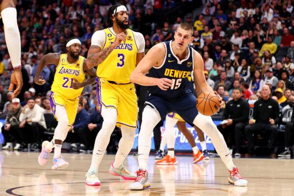 Nikola Jokic (15) of the Denver Nuggets drives against Anthony Davis (3) of the Los Angeles Lakers at Ball Arena in Denver, Colo., on Oct. 26, 2022. (Jamie Schwaberow/Getty Images)