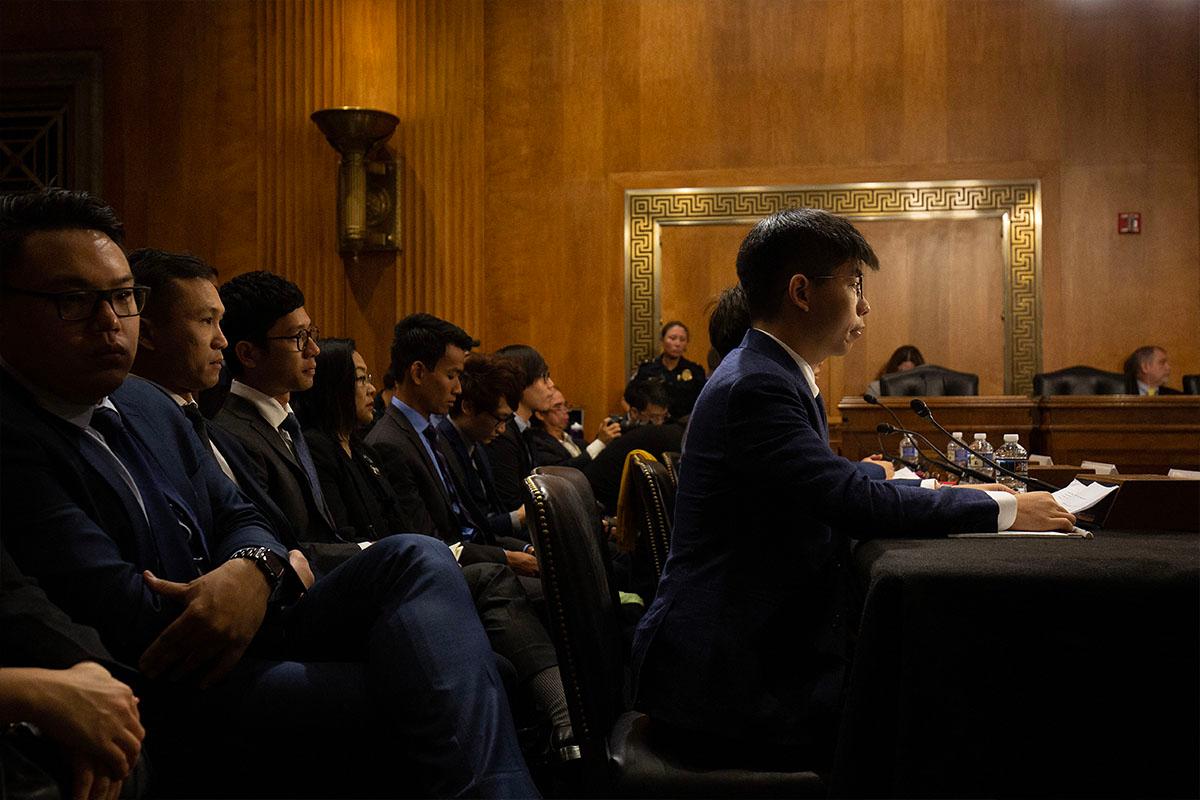 Hong Kong pro-democracy activists Joshua Wong (C) and Nathan Law (third from L) speak with U.S. Representative Jim McGovern before the Congressional-Executive Commission on China at the Dirksen Senate Office Building on Capitol Hill in Washington, on Sept. 17, 2019. Leaders of Hong Kong's pro-democracy movement appealed directly to U.S. lawmakers to exert pressure on Beijing, warning that an erosion of the city's special status would embolden China's leaders around the world. (Alastair Pike/AFP)