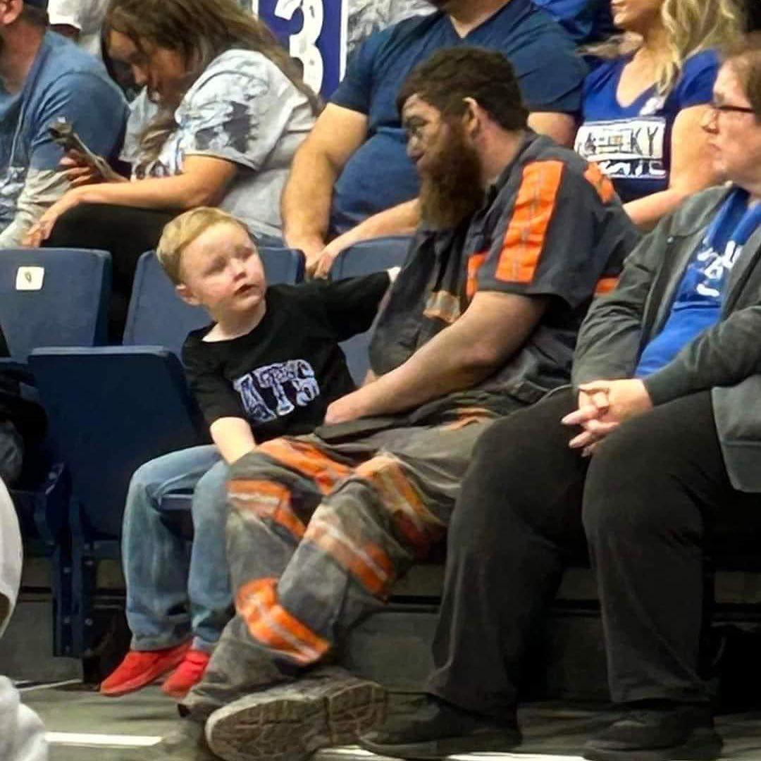 Micheal Joe McGuire, still in uniform, with his son and wife at the University of Kentucky's men's basketball game at Appalachian Wireless Arena in Pikeville, Kentucky. (Courtesy of Sue Kinneer)