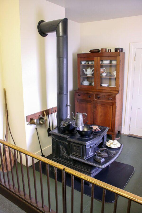 The Royal Oak cast-iron wood stove that the Lincolns used daily was made in Buffalo, New York, and would still be in working order if it was once again hooked up to a chimney flue. This stove was considered multifunctional in that it helped warm the home, had an oven and stove top, kept cooked food warm on its front hearth, and heated actual cast irons for pressing clothing. (Courtesy of the National Park Service)