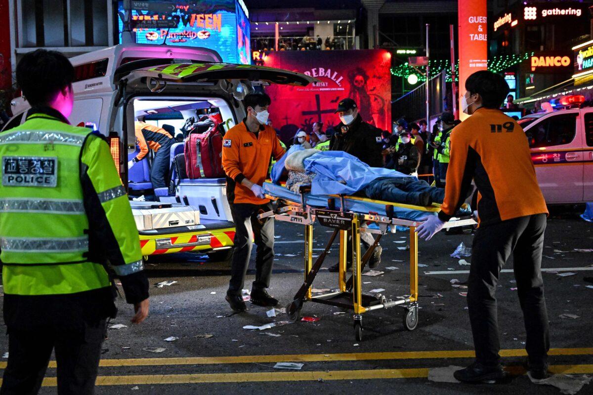 Medical staff transport a victim, believed to have suffered cardiac arrest, in the popular nightlife district of Itaewon in Seoul, South Korea, on Oct. 30, 2022. (Jung Yeon-je/AFP via Getty Images)