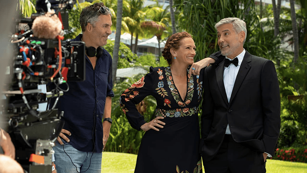 (L–R) Director Ol Parker, Julia Roberts, and George Clooney on set in "Ticket to Paradise." (Universal Pictures)