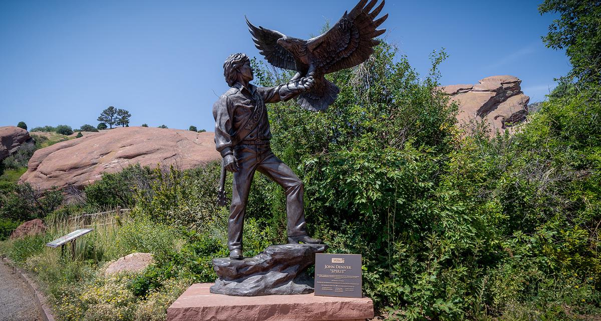 The John Denver “Spirit” statue, now located at the Colorado Music Hall of Fame at Red Rocks, was constructed in honor of Denver’s passion for nature and the environment. (melissamn/Shutterstock)