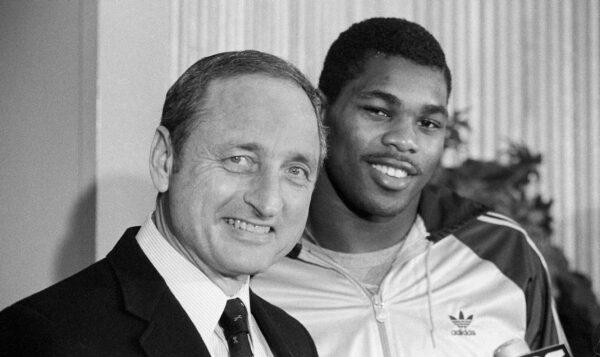 Georgia running back Herschel Walker (R) brings a smile to the face of his coach Vince Dooley as he announces that he would play football next year at Georgia rather than the USFL, in Athens, Ga., on Feb. 8, 1983. (Joe Holloway Jr.,/AP Photo)