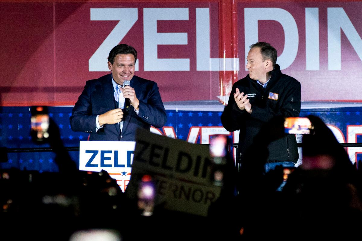  Florida Gov. Ron DeSantis and Republican gubernatorial nominee Rep. Lee Zeldin (R-N.Y.) speak at a “Get Out the Vote" rally in Hauppauge, N.Y., on Oct. 29, 2022. (Chung I Ho/The Epoch Times)