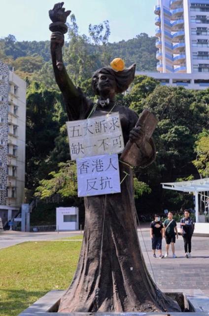 On Nov 7, 2019, around the statue of the Goddess of Democracy at the Chinese University of Hong Kong, students put up different slogans to express their protest. (Sung Pi-lung/The Epoch Times)