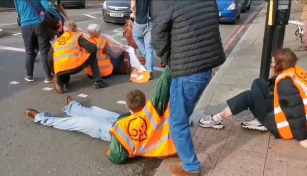 Screengrab from a video posted by Just Stop Oil of one of their activists being dragged off the street at Harleyford Street, just off Kennington Park Road, London, on Oct. 29, 2022. (PA Media/Just Stop Oil)