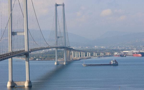 The Turkish-flagged cargo ship Polarnet, carrying Ukrainian grain, passes by the Osmangazi Bridge entering the Gulf of Izmit in Turkey on Aug. 8, 2022. (Yoruk Isik/Reuters)