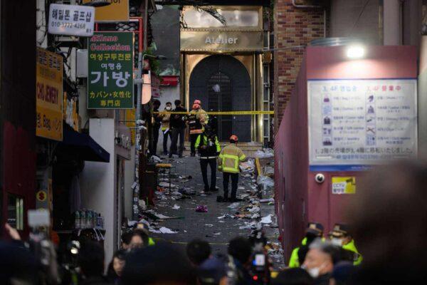 Emergency service personnel are seen in the alley where a Halloween crowd surge took place late Oct. 29, in the neighborhood of Itaewon in Seoul on Oct. 30, 2022. (Anthony Wallace/AFP via Getty Images)