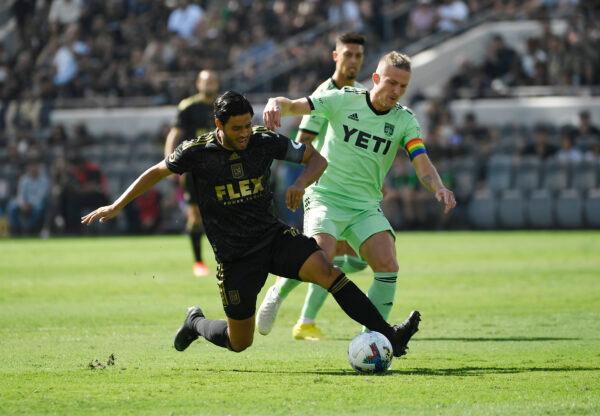 Carlos Vela (10) of Los Angeles FC is tackled by Alexander Ring (8) of Austin FC during the first half of the Western Conference Finals of the 2022 MLS Cup Playoffs at Banc of California Stadium in Los Angeles, on Oct. 30, 2022. (Kevork Djansezian/Getty Images)