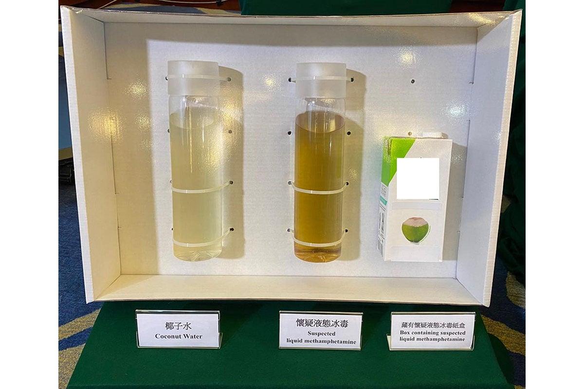 Hong Kong Customs shows samples of coconut water, suspected liquid methamphetamine, and a box containing the suspected methamphetamine. (Courtesy of News.gov.hk)