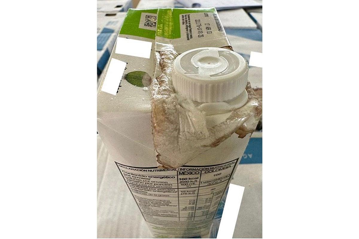 Smudges and white crystals are found on the carton, and there were painted arrows and leakage near the caps of coconut water bottles containing the suspected liquid methamphetamine. (Courtesy of News.gov.hk)