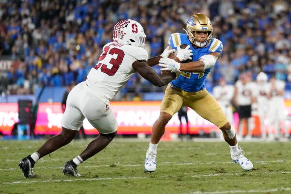 UCLA running back Zach Charbonnet (24) is tackled by Stanford defensive end David Bailey (23) during the first half of an NCAA college football game in Pasadena, Calif., on Oct. 29, 2022. (Ashley Landis/AP Photo)