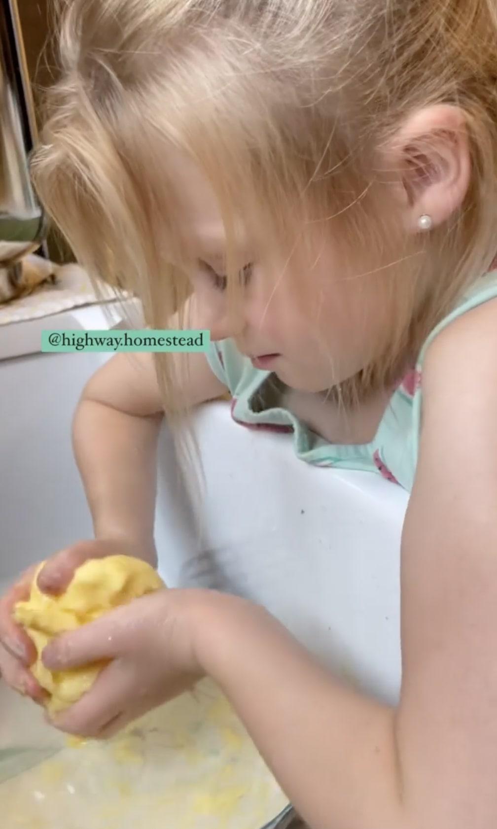 Cortney and Samuel Black's daughter learning how to make butter. (Courtesy of Cortney Black)