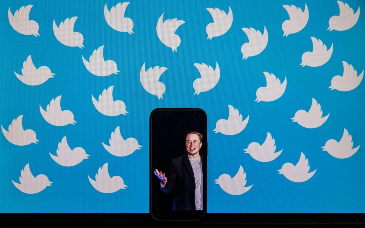 Illustration of a cellphone displaying a photo of Elon Musk placed on a computer monitor filled with Twitter logos in Washington, on Aug. 5, 2022. (Samuel Corum/AFP via Getty Images)