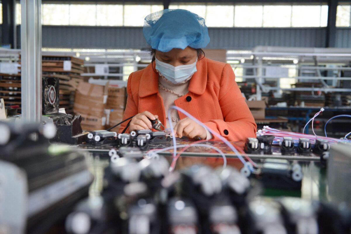 An employee works on an assembly line producing speakers at a factory in Fuyang city, in China's eastern Anhui Province on Oct. 31, 2022. (STR/AFP via Getty Images)
