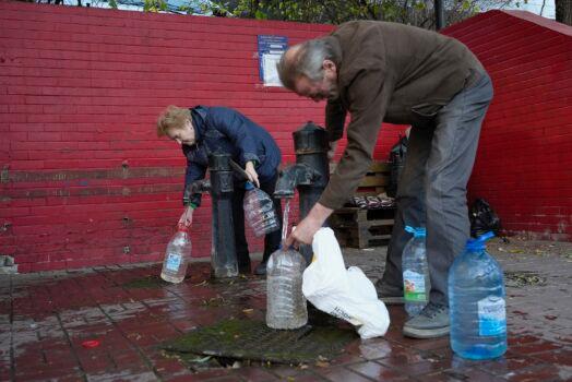 People fill containers with water from public water pumps in Kyiv, Ukraine, on Oct. 31, 2022. (Sam Mednick/AP Photo)