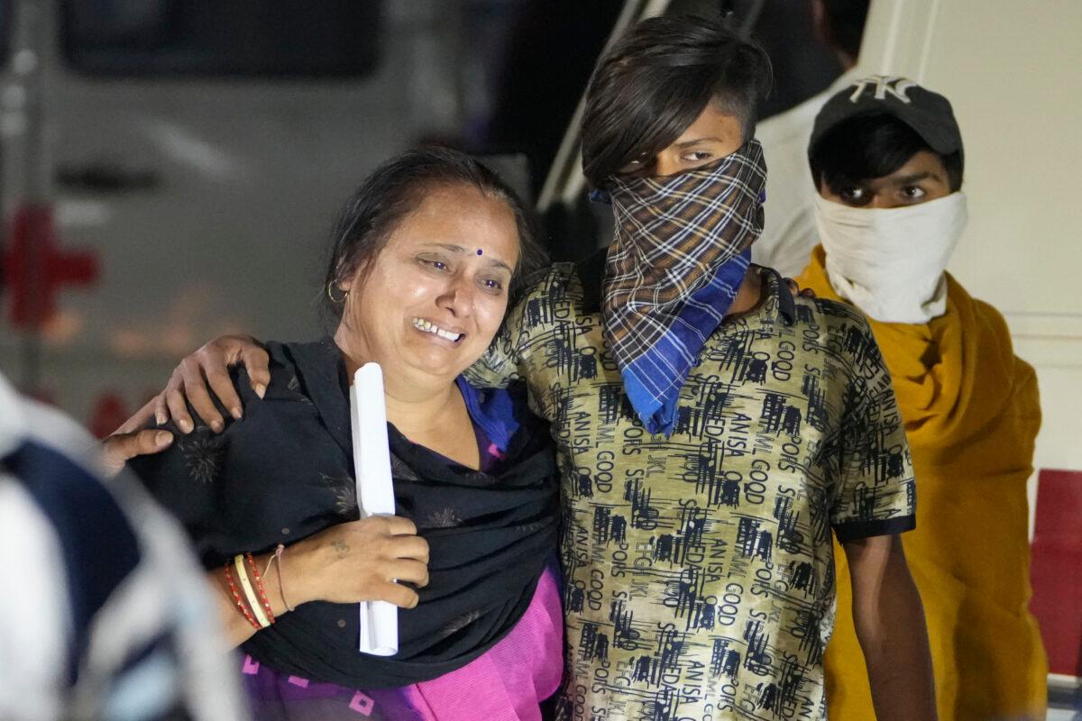 Relatives of a victim mourn after a cable bridge across the Machchu river collapsed in Morbi town of western state Gujarat, India, on Oct. 31, 2022. (Ajit Solanki/AP Photo)