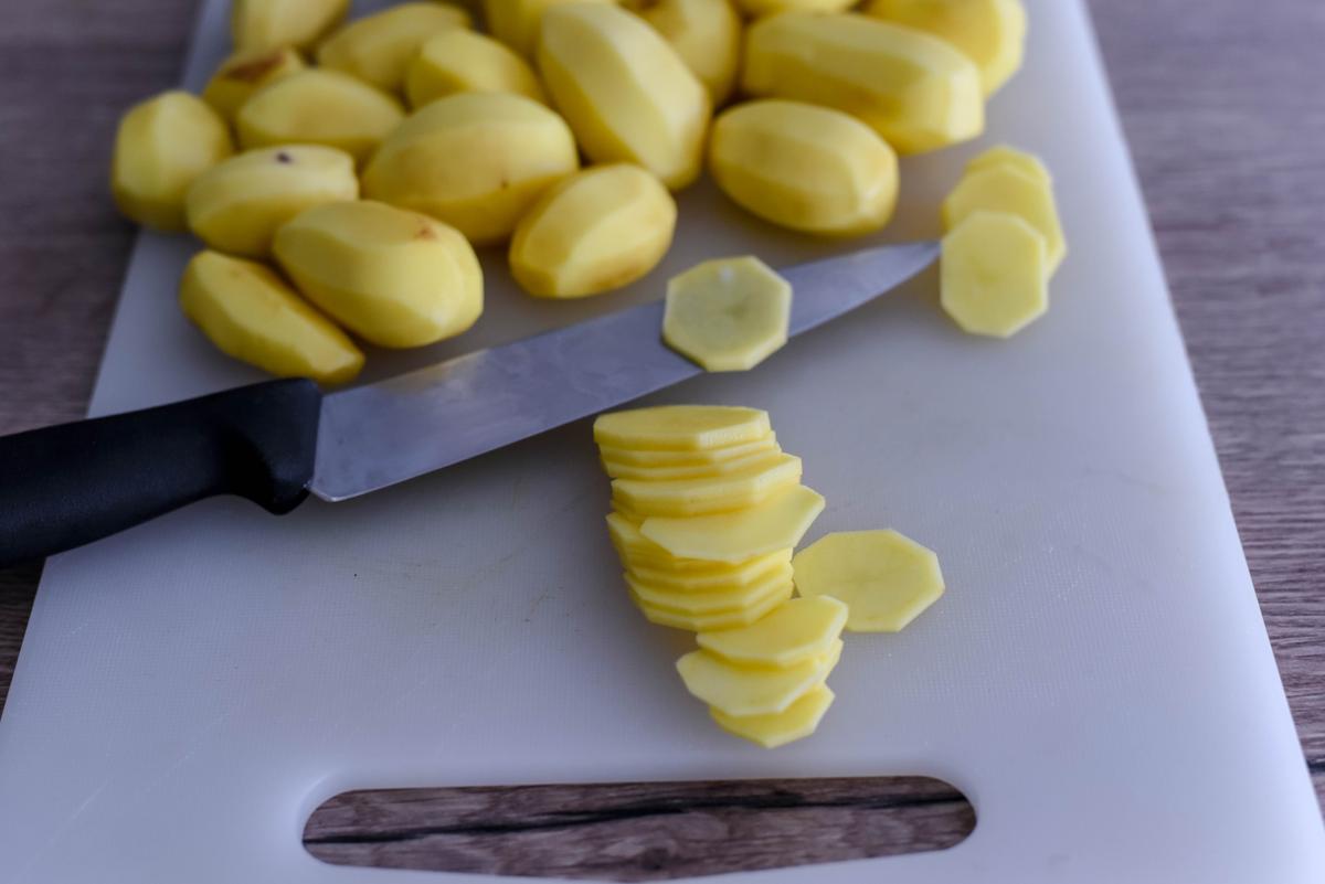 Thinly slice the potatoes with a mandoline or sharp knife. (Audrey Le Goff)