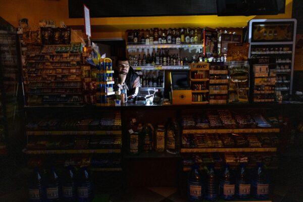 At a BRSM gas station, an employee stands inside the shop during a power outage in Kyiv, Ukraine, on Oct. 28, 2022. (Paula Bronstein/Getty Images)