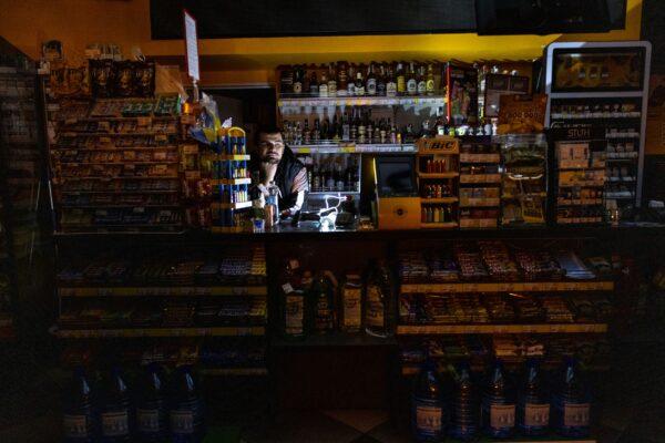 At a BRSM gas station, an employee stands inside the shop during a power outage in Kyiv, Ukraine, on Oct. 28, 2022. (Paula Bronstein/Getty Images)