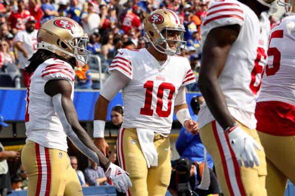 Brandon Aiyuk (11) of the San Francisco 49ers and Jimmy Garoppolo (10) celebrates a touchdown during the second quarter against the Los Angeles Rams at SoFi Stadium in Inglewood, Calif., on Oct. 30, 2022. (Harry How/Getty Images)