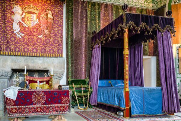 The lavish Queen's Bedchamber is richly decorated with a tapestry, curtains, and furniture inspired by the German style. Renaissance details include the use of tapestry, the fireplace at the left of the room, and the luxuriously draped fabric. (<a href="https://www.shutterstock.com/g/JaroslavMoravcik">Jaroslav Moravcik</a>/<a href="https://www.shutterstock.com/image-photo/stirling-scotland-may-20-medieval-bedroom-1223287516">Shutterstoc</a>k)