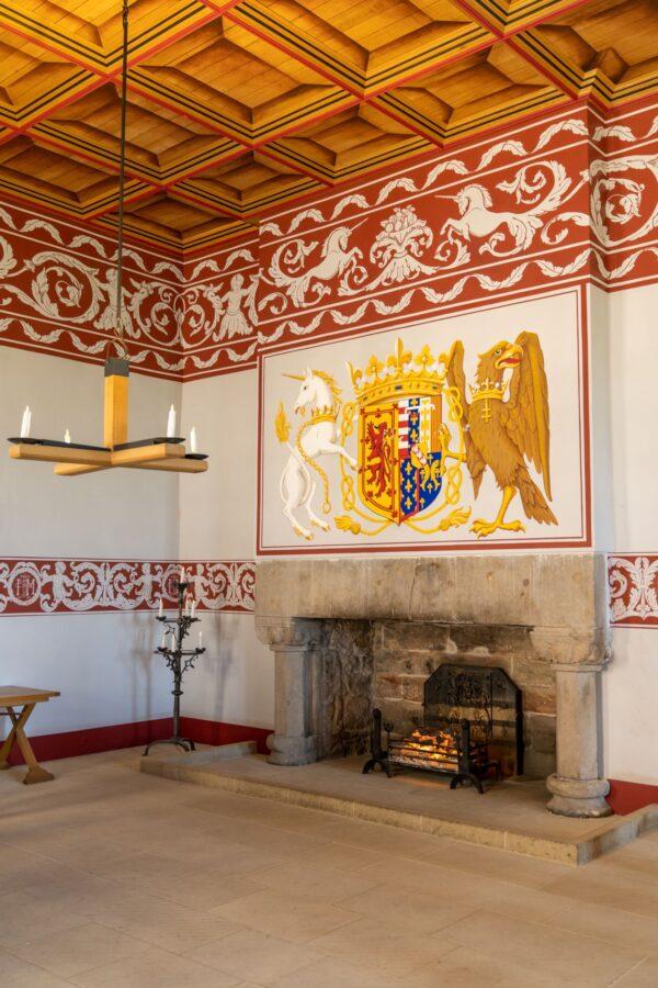 One of the many restored rooms of the royal palace. The wood ceiling, the fireplace as a focal point, the red frieze, and the tapestry featuring a unicorn and an eagle are typical features of the Renaissance style. (<a href="https://www.shutterstock.com/g/makasana+photo">makasana photo</a>/<a href="https://www.shutterstock.com/image-photo/stirling-united-kingdom-20-june-2022-2173930187">Shutterstock</a>)