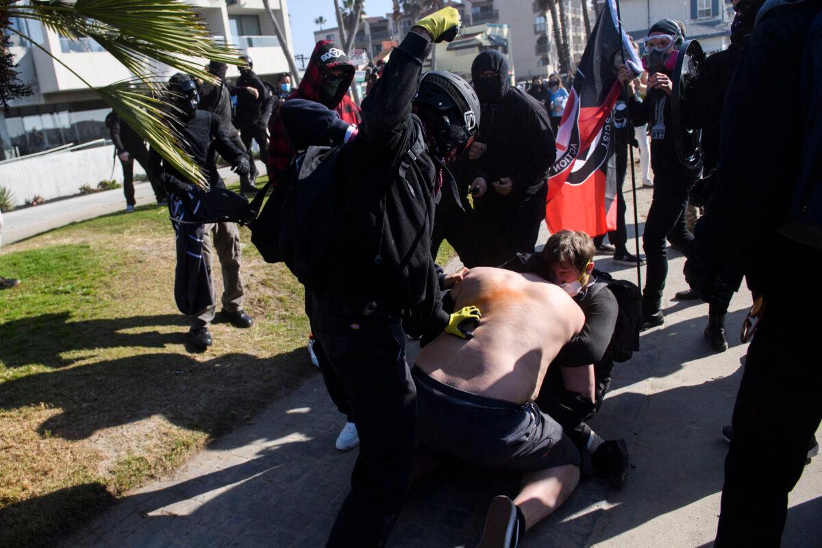 Counter-protesters attack demonstrators during a "Patriot March" demonstration in support of then President Donald Trump in the Pacific Beach neighborhood of San Diego on Jan. 9, 2021. (Patrick T. Fallon/AFP via Getty Images)