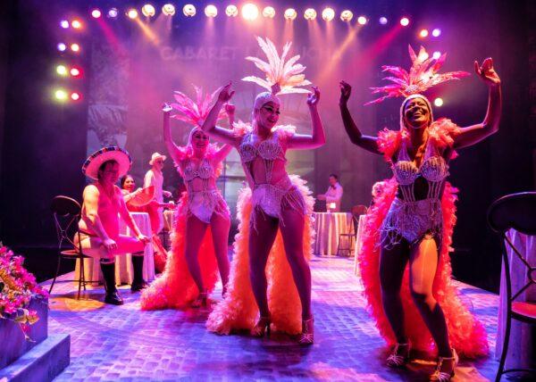 Nightclub performers (L–R: Alejandra Escalante, Kidany Camilo, and Kierra Bunch) sway and dance to Latin music in a Cuban nightclub in the opening scene from a modern adaptation of Shakespeare’s “Measure for Measure.” (Liz Lauren)