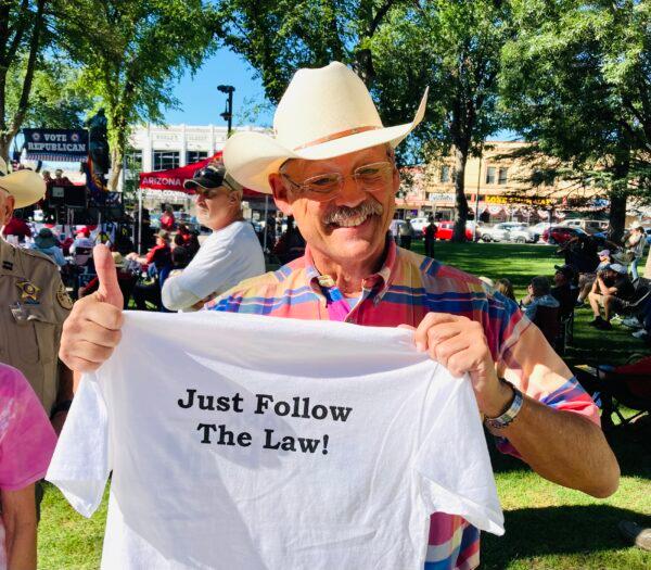 Arizona state Rep. Mark Finchem, the Republican candidate for Arizona secretary of state, holds a T-shirt bearing a campaign slogan at a recent political gathering in Prescott, Ariz. (Allan Stein/The Epoch Times)