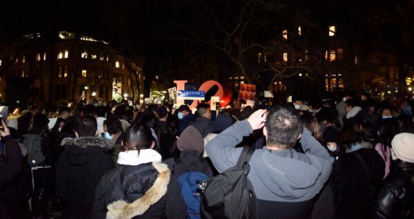 Hundreds of Chinese students from the University of Pennsylvania and their supporters gather near the statue of LOVE on Nov. 29, 2022, offering their condolences to victims of the Urumqi fire and supporting protesters in China. (Jing Song/The Epoch Times)