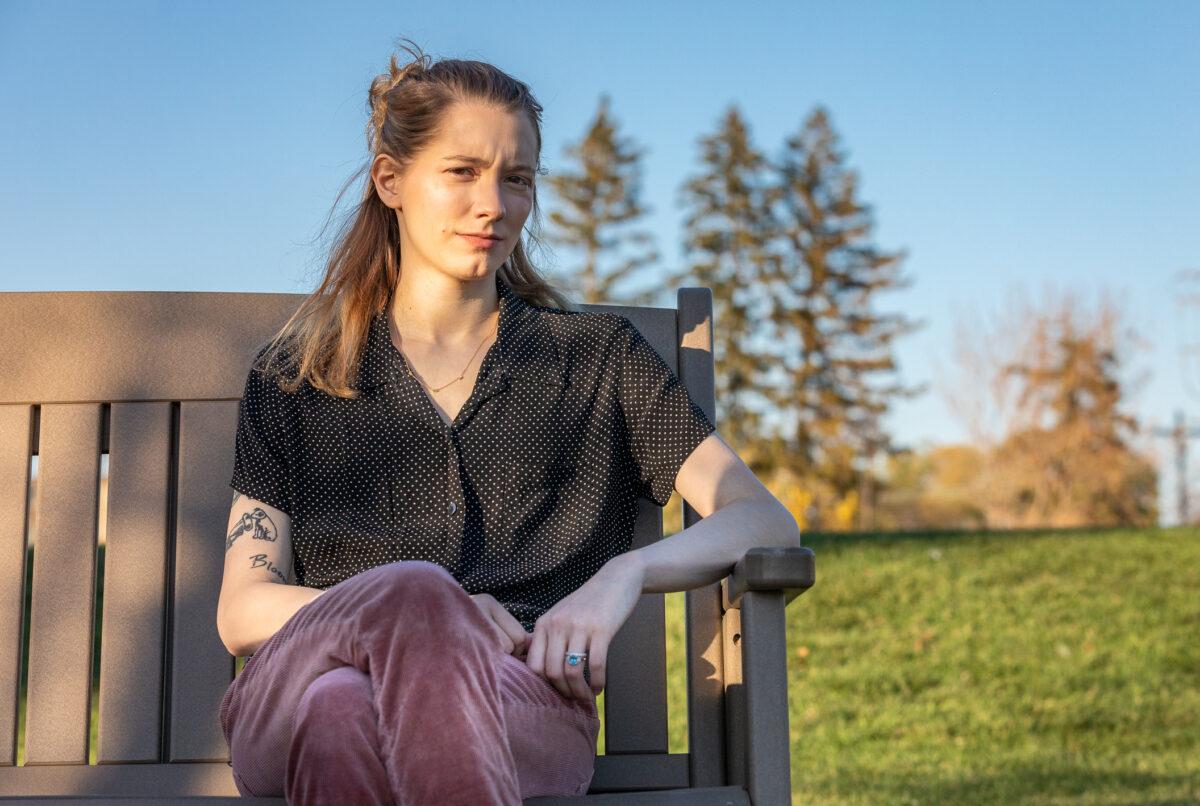 Detransitioner Daisy Strongin sits in a park in northeastern Illinois on Nov. 1, 2022. (John Fredricks/The Epoch Times)