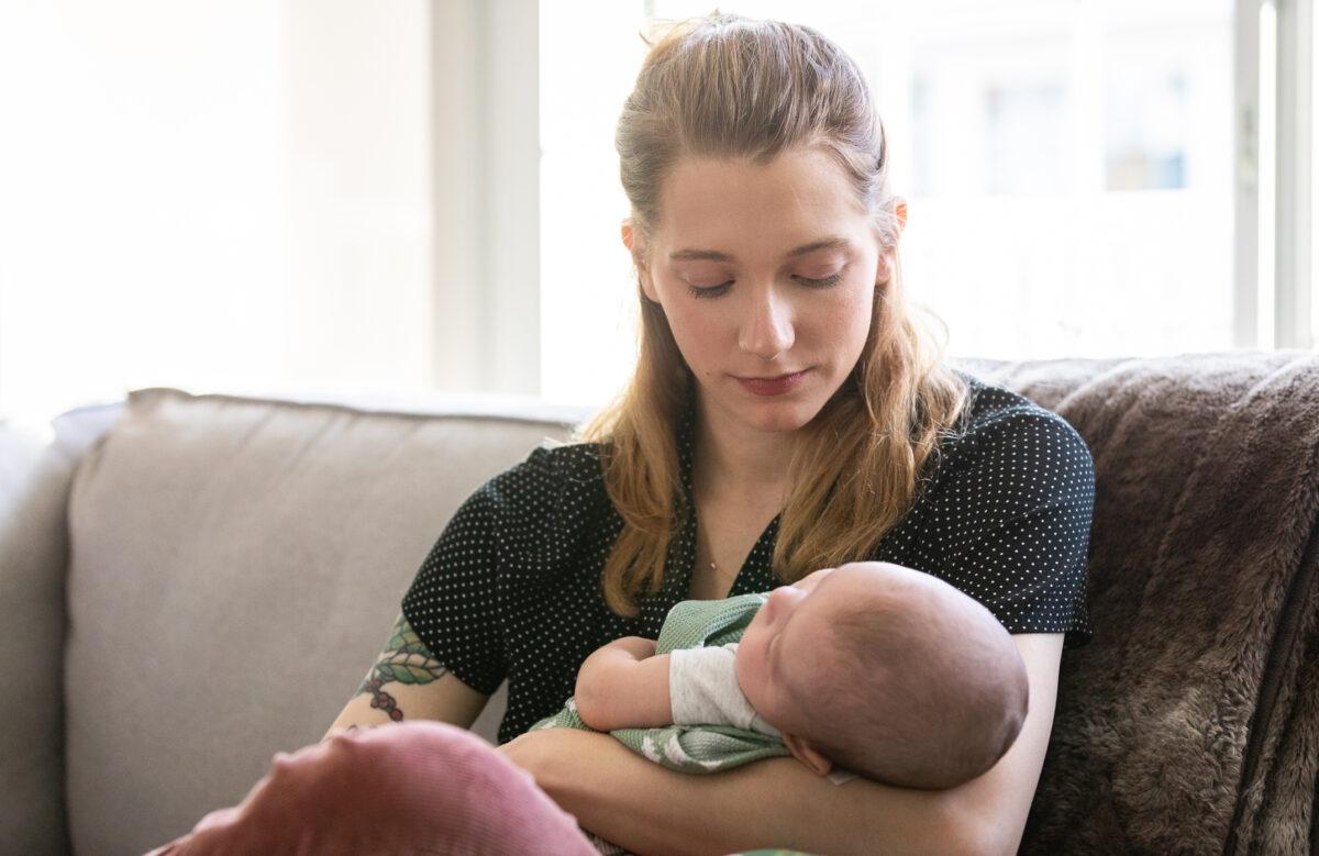 Detransitioner Daisy Strongin holds her son in northeastern Illinois on Nov. 1, 2022. (John Fredricks/The Epoch Times)