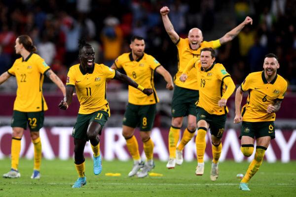Australia celebrate after winning the game in penalty shootouts in the 2022 FIFA World Cup Playoff match between Australia Socceroos and Peru at Ahmad Bin Ali Stadium in Doha, Qatar, on June 13, 2022. (Joe Allison/Getty Images)