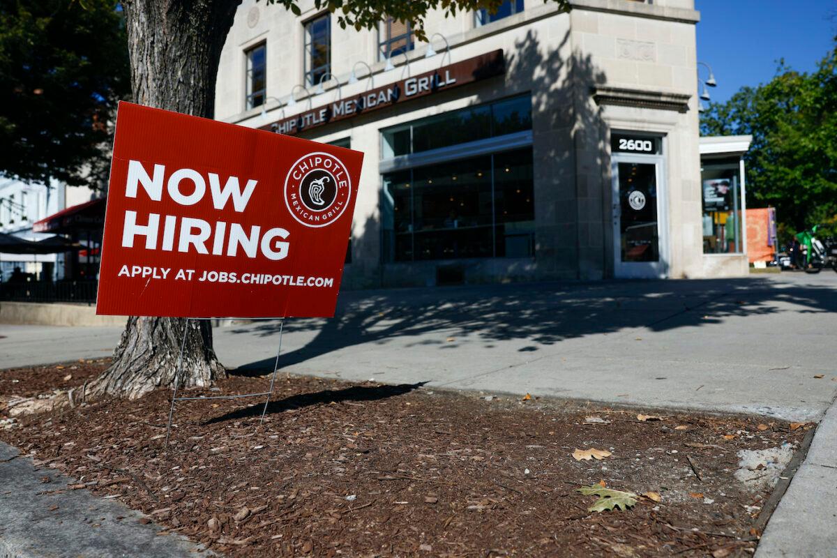 A "Now Hiring" sign in front of a Chipotle restaurant in Washington on Oct. 7, 2022. (Anna Moneymaker/Getty Images)
