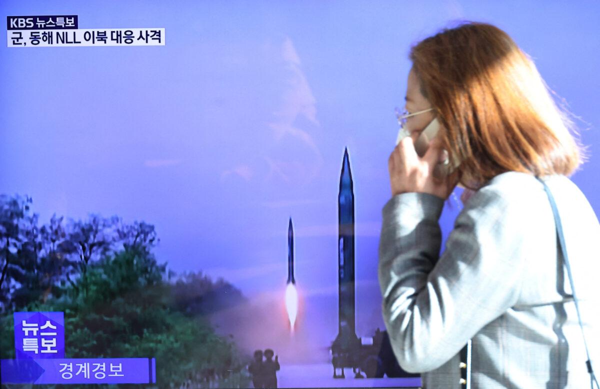 A woman walks past a TV screen broadcasting a news report on North Korea firing a ballistic missile off its east coast, in Seoul, South Korea, on Nov. 2, 2022. (Kim Hong-Ji/Reuters)