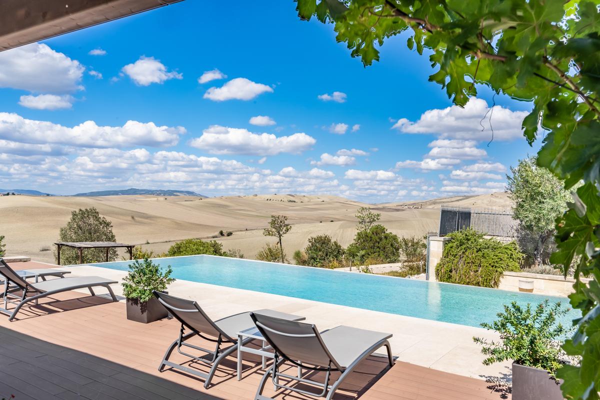 The magnificent view, enjoyed by those in the pool area, of the striking landscapes surrounding the property. (Courtesy of Sotheby’s Concierge Auctions)