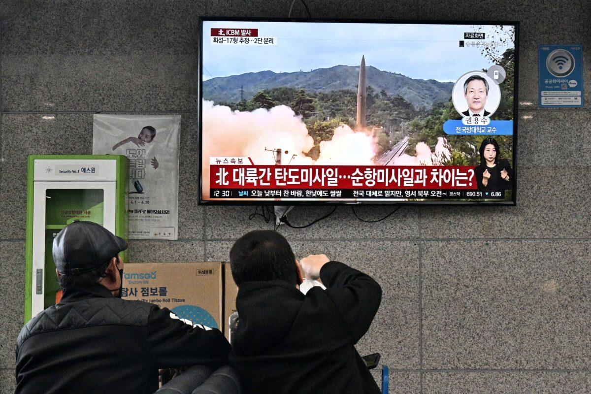 Visitors watch a news broadcast showing file footage of a North Korean missile test at the ferry terminal of South Korea's eastern island of Ulleungdo, in the East Sea, also known as the Sea of Japan, on Nov. 3, 2022. (Anthony Wallace/AFP/Getty Images)