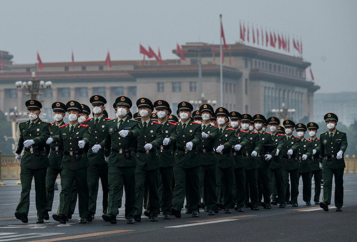 Members of the People's Armed Police march in formation after the annual flag-raising ceremony to mark China's national day next to Tiananmen Square on Oct. 1, 2022, in Beijing, China. (Kevin Frayer/Getty Images)