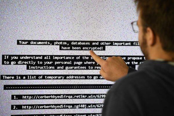An IT researcher shows on a giant screen a computer infected by a ransomware at a laboratory in Rennes, France, on Nov. 3, 2016. (Damien Meyer/AFP via Getty Images)